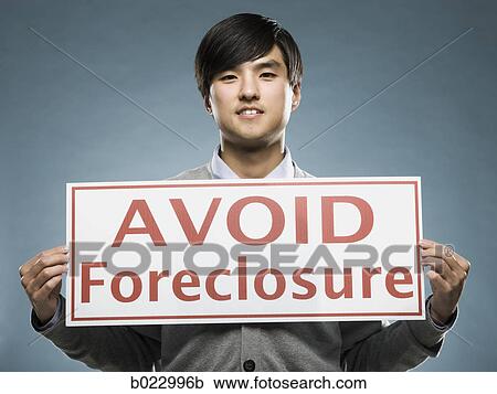 man holding an "avoid foreclosure" sign View Large Photo Image Stock Image - man holding an "avoid foreclosure" sign. Fotosearch