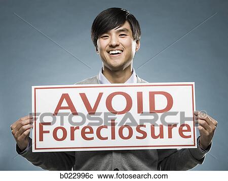 man holding an "avoid foreclosure" sign View Large Photo Image Stock Image - man holding an "avoid foreclosure" sign. Fotosearch