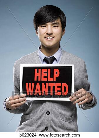 man holding help wanted sign View Large Photo Image Picture - man holding help wanted sign. Fotosearch