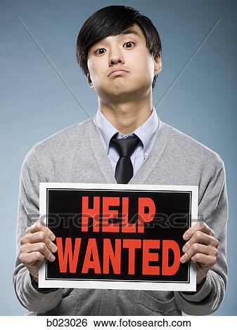 man holding help wanted sign View Large Photo Image Stock Photograph - man holding help wanted sign. Fotosearch