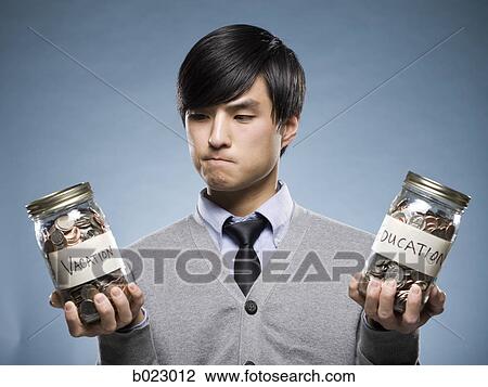 man holding two jars of coins View Large Photo Image Stock Image - man holding two jars of coins. Fotosearch