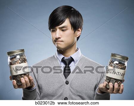 man holding two jars of coins View Large Photo Image Stock Image - man holding two jars of coins. Fotosearch