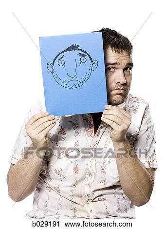 man holding up a frowny face drawing View Large Photo Image Stock Image - man holding up a frowny face drawing. Fotosearch