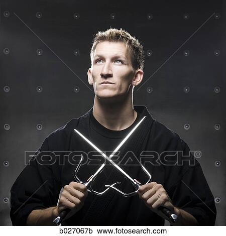 man in a black karate gi practicing martial arts View Large Photo Image Stock Image - man in a black karate gi practicing martial arts. Fotosearch