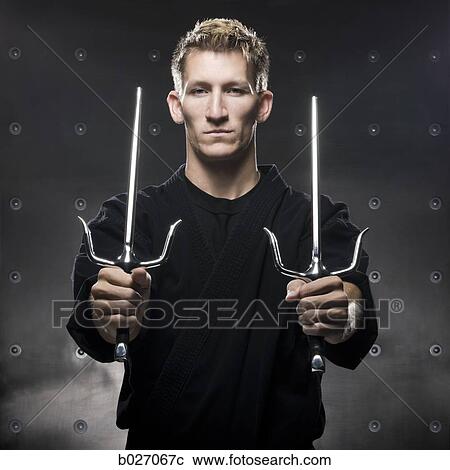 man in a black karate gi practicing martial arts View Large Photo Image Stock Image - man in a black karate gi practicing martial arts. Fotosearch