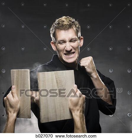 man in a black karate gi practicing martial arts View Large Photo Image Stock Image - man in a black karate gi practicing martial arts. Fotosearch