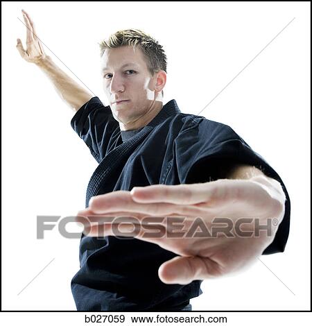man in a black karate gi practicing martial arts View Large Photo Image Stock Photo - man in a black karate gi practicing martial arts. Fotosearch