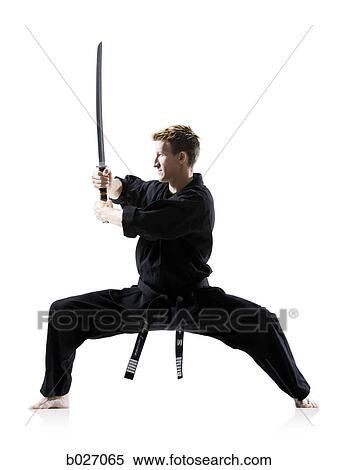 man in a black karate gi practicing martial arts View Large Photo Image Stock Photography - man in a black karate gi practicing martial arts. Fotosearch