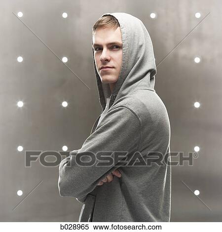 man in a hoodie with arms folded View Large Photo Image Stock Photography - man in a hoodie with arms folded. Fotosearch