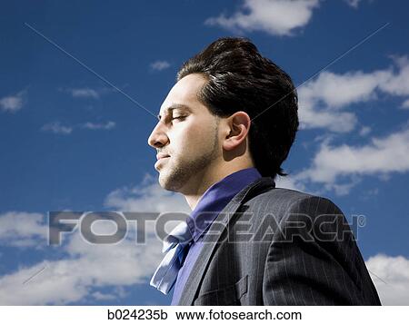 man in a suit with head tilted back View Large Photo Image Stock Image - man in a suit with head tilted back. Fotosearch