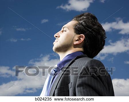 man in a suit with head tilted back View Large Photo Image Stock Photography - man in a suit with head tilted back. Fotosearch
