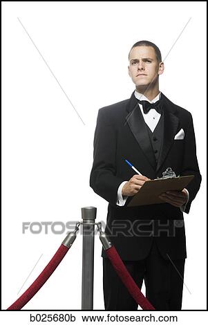 Stock Image - man in a tuxedo next to a velvet rope. Fotosearch