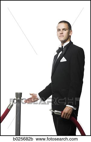 man in a tuxedo next to a velvet rope View Large Photo Image Stock Image - man in a tuxedo next to a velvet rope. Fotosearch
