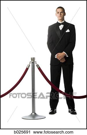 man in a tuxedo next to a velvet rope View Large Photo Image Stock Image - man in a tuxedo next to a velvet rope. Fotosearch