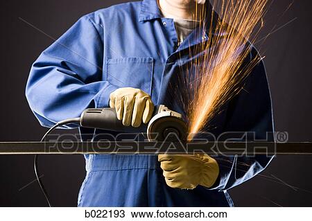 man in blue coveralls with a power grinder View Large Photo Image Stock Image - man in blue coveralls with a power grinder. Fotosearch