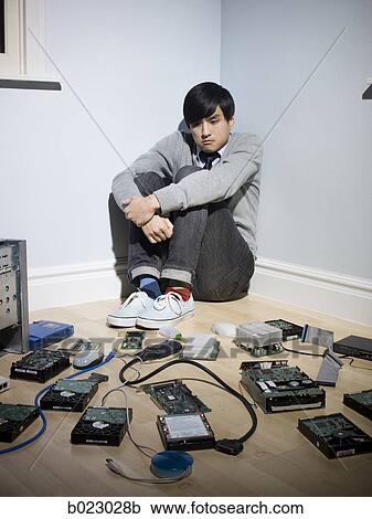 man in the corner surrounded by computer parts View Large Photo Image Stock Image - man in the corner surrounded by computer parts. Fotosearch