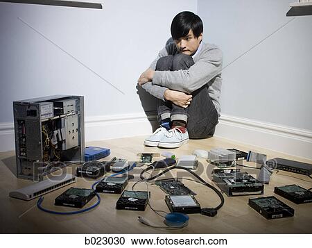 man in the corner surrounded by computer parts View Large Photo Image Stock Image - man in the corner surrounded by computer parts. Fotosearch