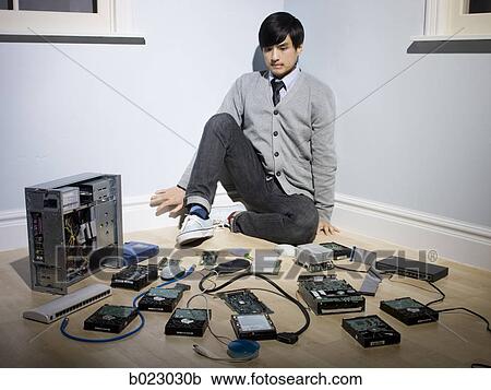 man in the corner surrounded by computer parts View Large Photo Image Stock Image - man in the corner surrounded by computer parts. Fotosearch