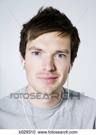 man listening to earphones View Large Photo Image Stock Image - man listening to earphones. Fotosearch