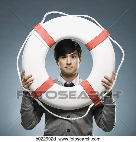 man looking through the hole of a life preserver View Large Photo Image Stock Image - man looking through the hole of a life preserver. Fotosearch