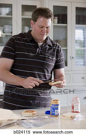 Stock Photography - man making a school lunch. Fotosearch