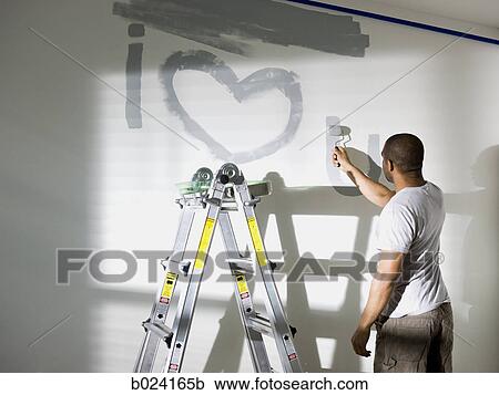 man painting a room View Large Photo Image Stock Image - man painting a room. Fotosearch