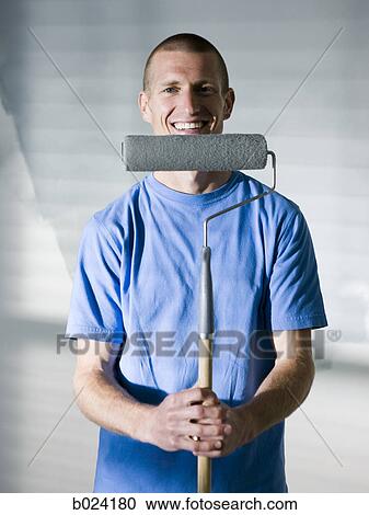 man painting a room View Large Photo Image Stock Image - man painting a room. Fotosearch