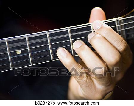 Stock Image - man playing a guitar. Fotosearch