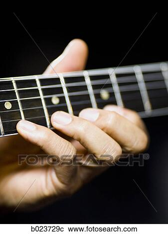 Stock Image - man playing a guitar. Fotosearch