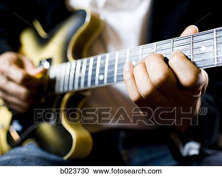 man playing a guitar View Large Photo Image Stock Image - man playing a guitar. Fotosearch