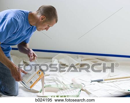 man pouring paint into a roller tray View Large Photo Image Stock Photography - man pouring paint into a roller tray. Fotosearch