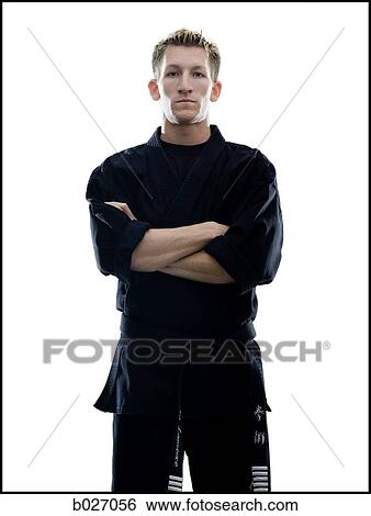 Stock Photograph - man standing in a black karate gi with arms crossed. Fotosearch