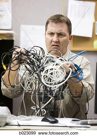 man trying to figure out computer wiring View Large Photo Image Stock Photo - man trying to figure out computer wiring. Fotosearch
