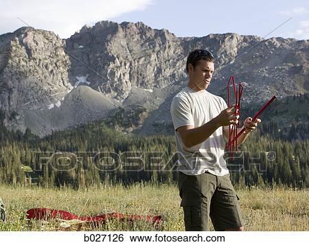 man trying to put together a ten View Large Photo Image Stock Photograph - man trying to put together a ten. Fotosearch