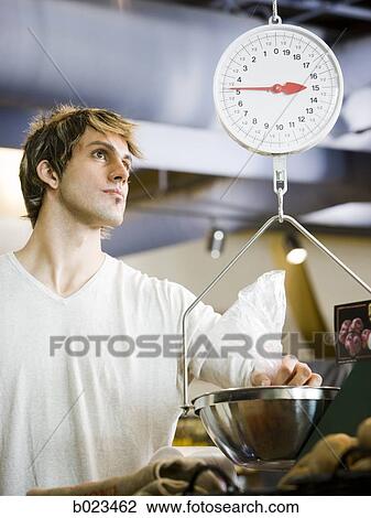 man using a scale at the supermarket View Large Photo Image Stock Image - man using a scale at the supermarket. Fotosearch