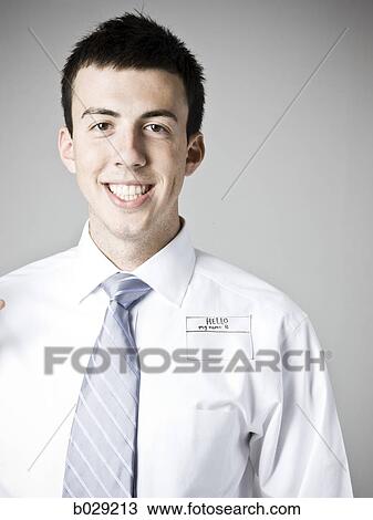 Stock Image - man wearing a tag that says hello, my name is. Fotosearch
