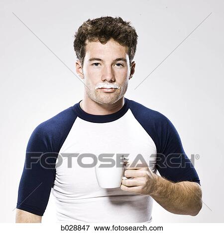 Stock Photo - man with a milk moustache holding a white mug. Fotosearch