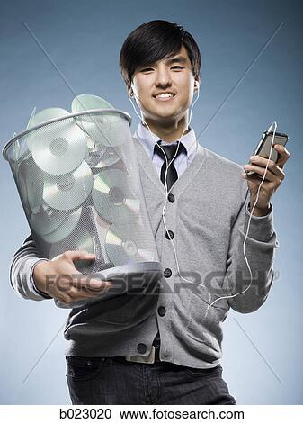 man with a trash can full of cd's and holding an iPod View Large Photo Image Stock Image - man with a trash can full of cd's and holding an iPod. Fotosearch