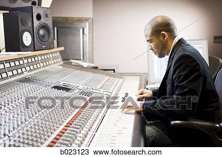 Stock Image - man working in a recording studio. Fotosearch