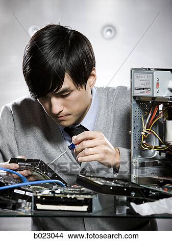 man working on a computer View Large Photo Image Picture - man working on a computer. Fotosearch