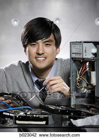 man working on a computer View Large Photo Image Stock Image - man working on a computer. Fotosearch