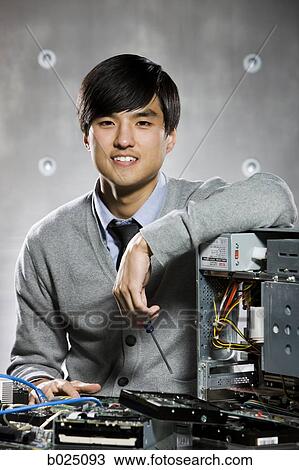 Stock Image - man working on a computer. Fotosearch
