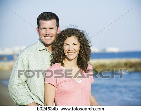 Stock Image - mid adult couple at the beach. Fotosearch
