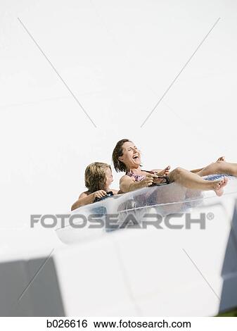 mom and daughter on a waterslide View Large Photo Image Stock Photograph - mom and daughter on a waterslide. Fotosearch