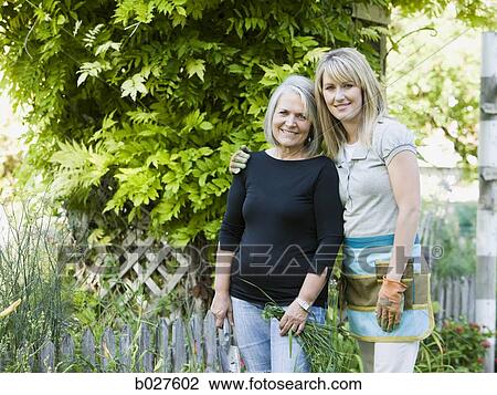 mother and adult daughter in the garden together View Large Photo Image Stock Image - mother and adult daughter in the garden together. Fotosearch