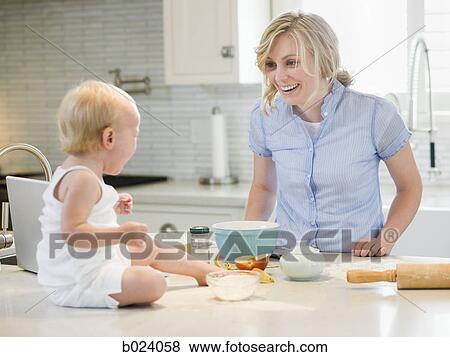 mother and baby girl cooking in the kitchen View Large Photo Image Stock Photo - mother and baby girl cooking in the kitchen. Fotosearch