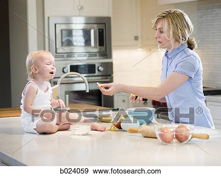 mother and baby girl cooking in the kitchen View Large Photo Image Stock Photo - mother and baby girl cooking in the kitchen. Fotosearch