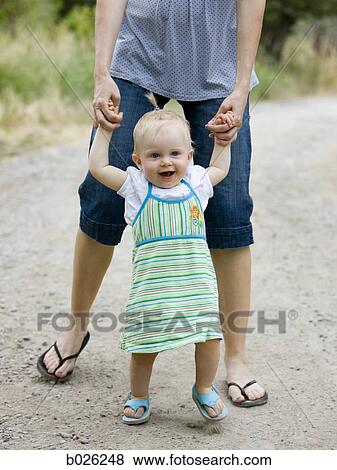 mother and baby girl learning to walk View Large Photo Image Stock Photo - mother and baby girl learning to walk. Fotosearch