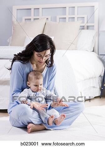 Stock Image - mother and baby in a bedroom. Fotosearch