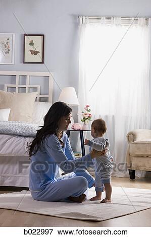 Stock Photo - mother and baby in a bedroom. Fotosearch